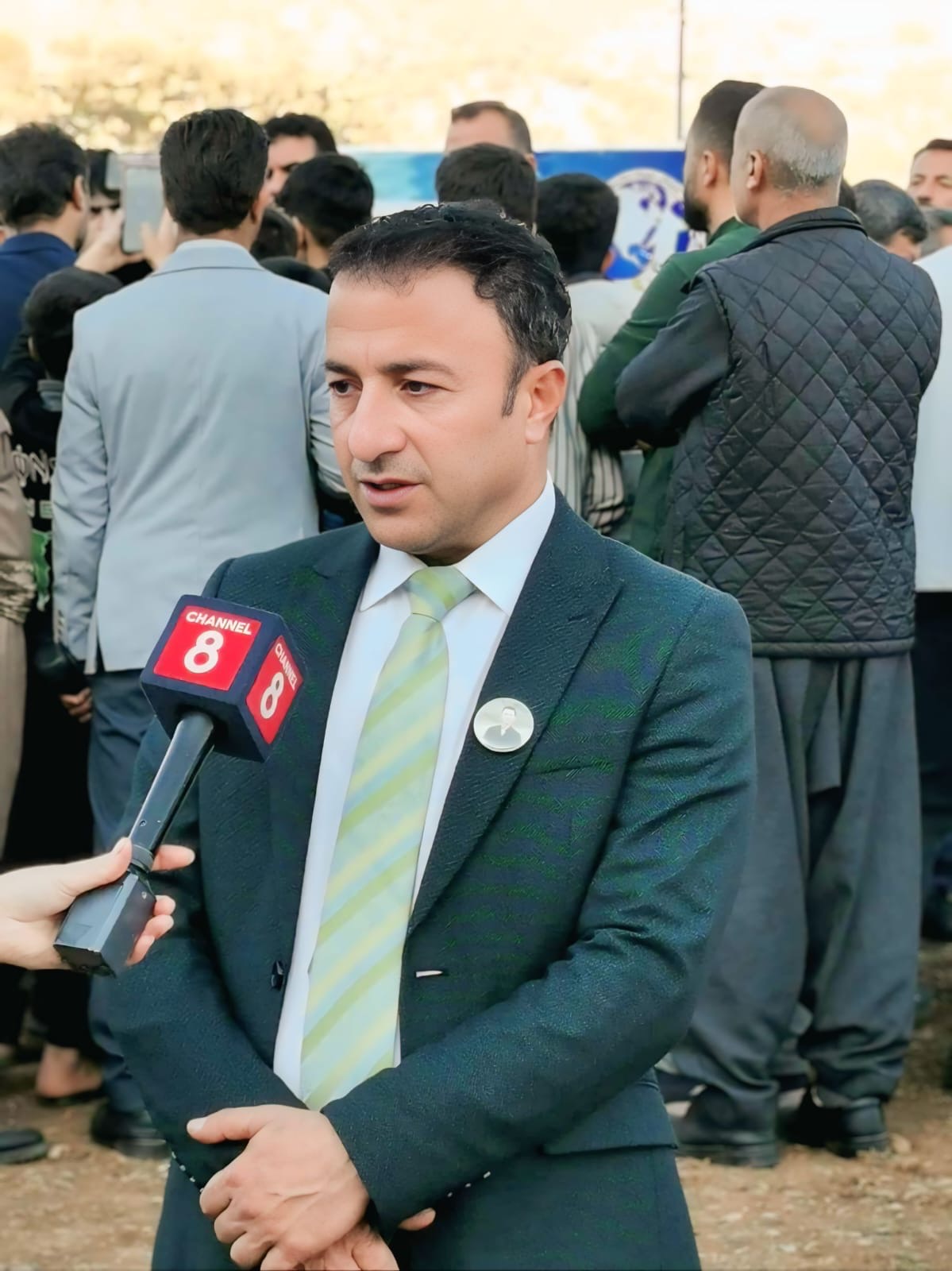 Association representative interviewed by Channel 8 during a public activity.