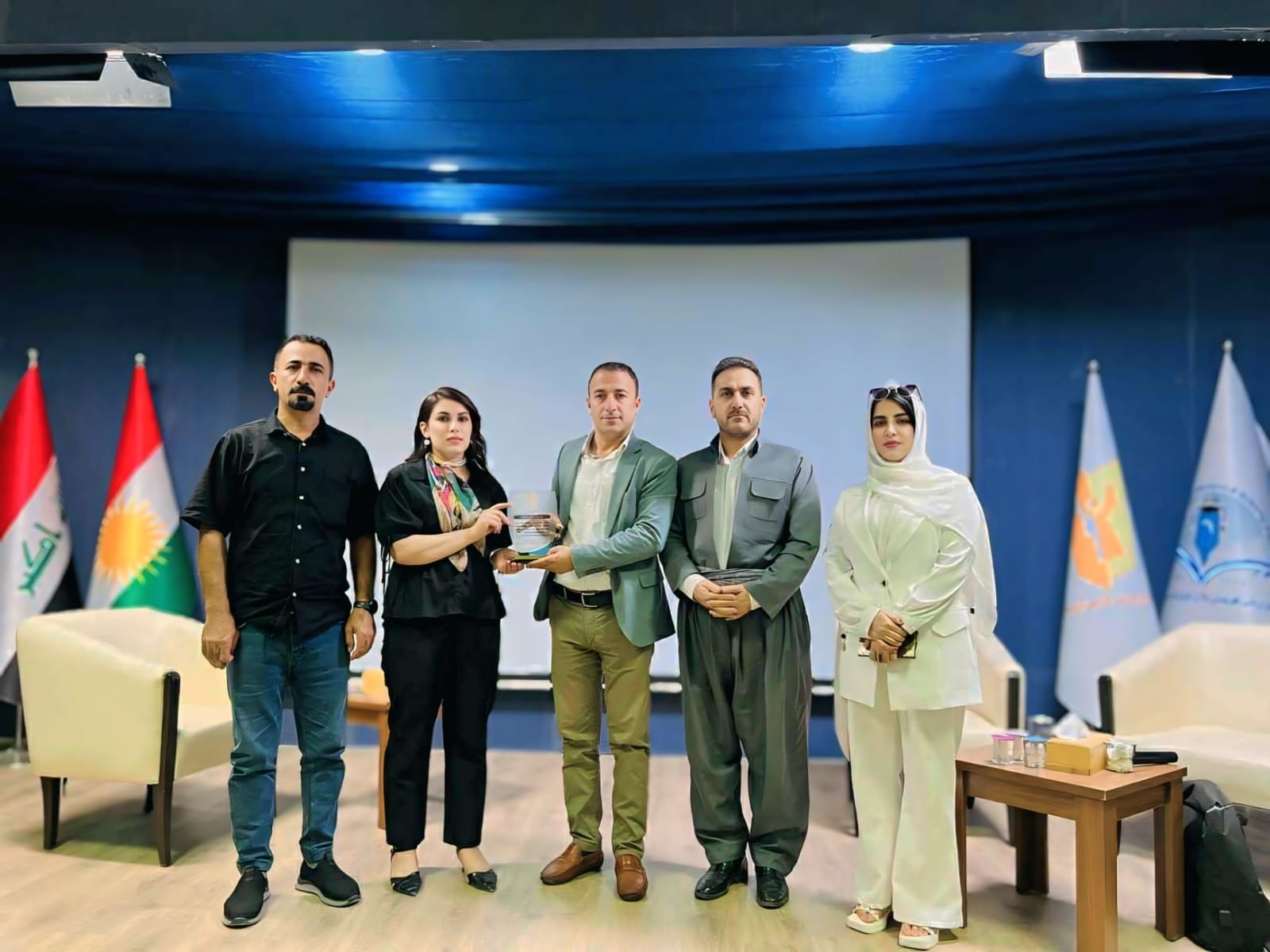 Association representatives receiving a commemorative plaque at an academic event recognising cooperation on reintegration research.