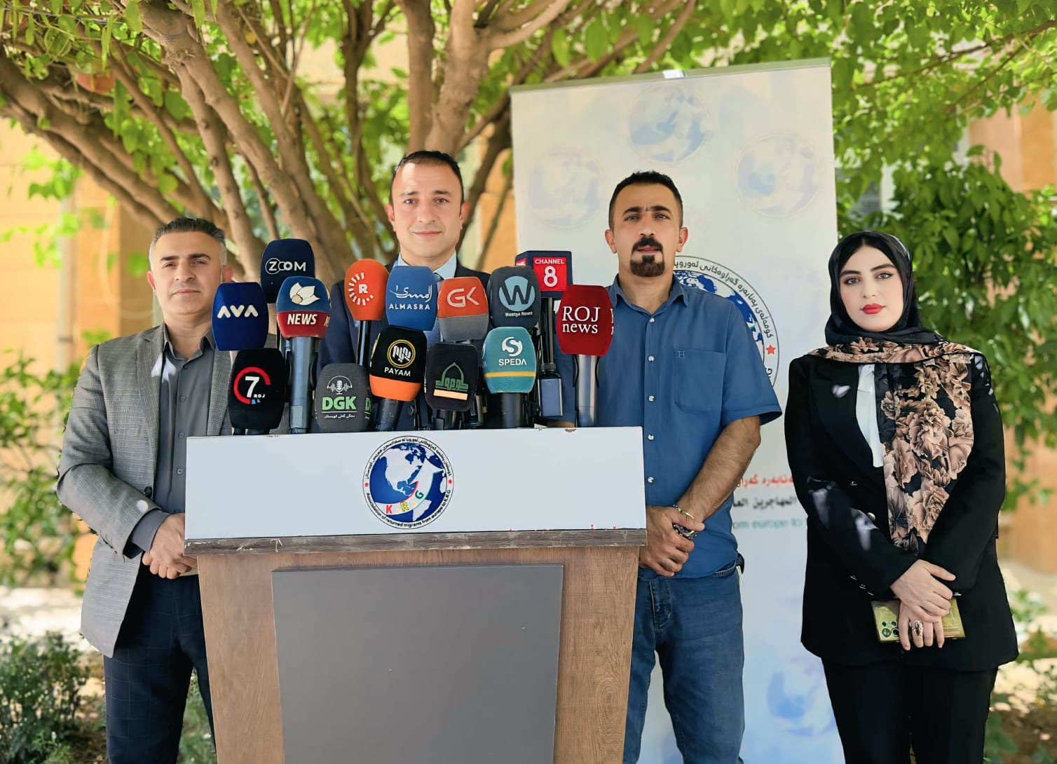 Association spokesperson team addressing a joint press conference attended by Kurdish and regional networks including Rudaw, Channel 8, Roj News, and Speda.